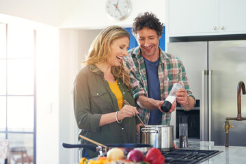 Love, salt and flavor with a couple cooking in the kitchen of their home together for health, diet...