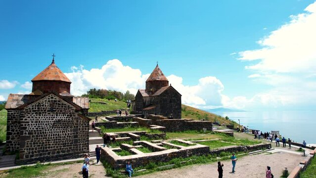 Aerial footage monastery on rock. Aerial footage Sevanavank near Sevan lake. Touristic place. Old architecture in Armenia, aerial view of Sevanavank monastery complex. 