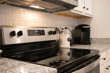 Kitchen Counter Stovetop with Utensils and Coffee Maker
