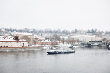 Fototapeta na wymiar Prague historical beautiful Landmarks in Pictures in winter time with boat and vltava river