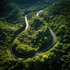 Winding road, top view of beautiful aerial view of asphalt road, highway through forest. For traveling and driving in nature