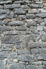 Grey grunge textured old stone wall.