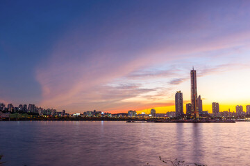 Fototapeta na wymiar View beside the Han River overlooking the skyscrapers at Yeouido after sunset, South Korea.