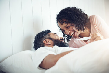 Couple, happy and laughter with pregnancy test, positive and bed with smile, results and excited. Man, woman and baby with stick, love and maternity for future family, surprise and pregnant together