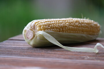 close up of corn on a wooden table