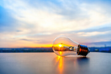 Close-up of Incandescent Light Bulb Against Setting Sun