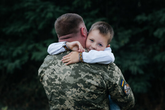 A little boy says goodbye to a soldier. The son hugs the father of the Ukrainian soldier. The Ukrainian defender said goodbye to his family. Mobilization of Ukrainian men. War in Ukraine