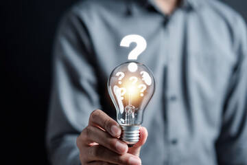 Businessman hand holding light bulb with brain into smart, creative, idea thinking to innovation brainstorm and imagination learning educate concept. - obrazy, fototapety, plakaty