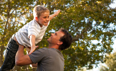 Obraz premium Dad, child and garden with airplane game, happy bonding and fun morning playing for father and son. Outdoor fun, love and playful energy, man holding boy in air and laughing in backyard together.
