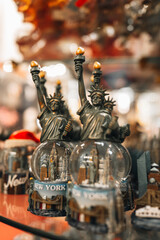Famous traditional gifts and souvenirs Statue of Liberty with American flag in a store in Manhattan, New York. USA
