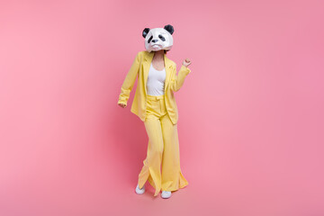 Full body photo of elegant cool lady 3d panda mask dancing have fun empty space isolated on pink...