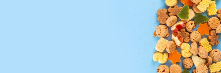 Sinterklaas, Saint Nicholas day background. Little kid red shoe with carrots and sweets, trooigoed, pepernoten, candy. Dutch Christmas holiday greeting card 