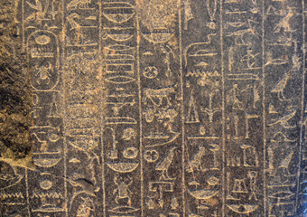 Ancient Egyptian folk letters on black stone in pyramid