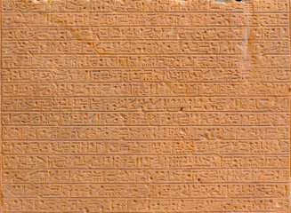 Ancient Egyptian script on red sandstone in pyramid