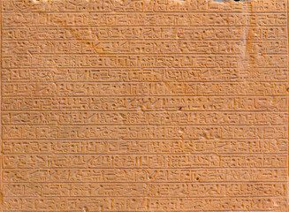 Ancient Egyptian script on red sandstone in pyramid
