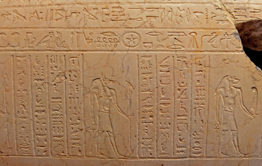 The walls of the room with stone carvings tell the story of the Egyptians in the pyramid