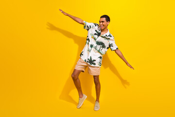 Full size photo of handsome young guy hands wigs flight playful dressed stylish palms print outfit...