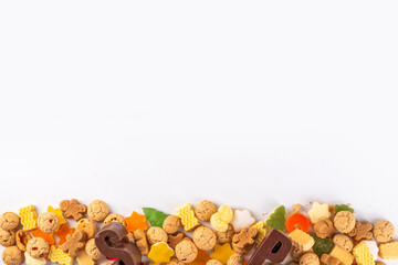 Sinterklaas, Saint Nicholas day background. Little kid red shoe with carrots and sweets, trooigoed,...