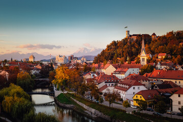 Cityscape of the Slovenian capital Ljubljana at sunset. Ljubljana castle on hill above town. River...