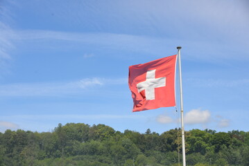 Swiss flag, blue sky background