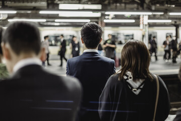 Passengers traveling by Tokyo metro. Business people commuting to work by public transport in rush...
