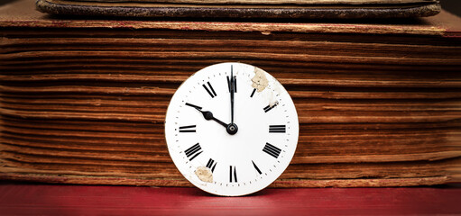 Old book and antique clock face. Storytelling, story teller, time background or banner.