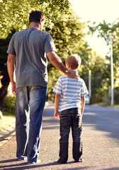 Back view, father and child walking on street together for bonding, support and love on vacation or holiday in summer. Care, talking and dad on road with kid in neighborhood on weekend as parent - obrazy, fototapety, plakaty