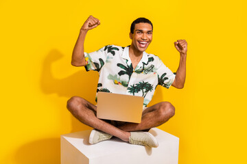 Full body photo of attractive young man white platform netbook dressed stylish palms print clothes isolated on yellow color background