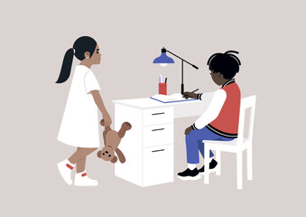 A bored child eager to play with their sibling who is engrossed in completing their preschool homework at the desk