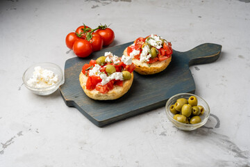 Cretan appetizer of tomatoes and cheese on a bun, Dakos.