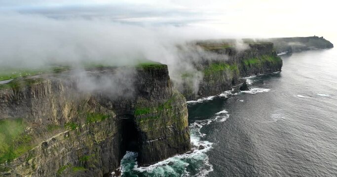 Aerial of coastal cliffs Moher shrouded in low clouds 4k
