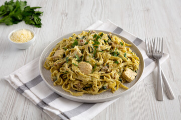 Homemade Creamy Chicken Bacon Pesto Pasta on a Plate, side view.