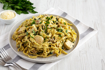 Homemade Creamy Chicken Bacon Pesto Pasta on a Plate, side view.