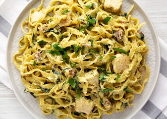 Homemade Creamy Chicken Bacon Pesto Pasta on a Plate, top view. Flat lay, overhead, from above.