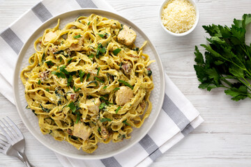 Homemade Creamy Chicken Bacon Pesto Pasta on a Plate, top view. Flat lay, overhead, from above.