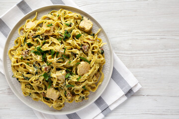 Homemade Creamy Chicken Bacon Pesto Pasta on a Plate, top view. Flat lay, overhead, from above. Copy space.