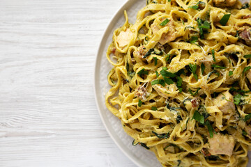 Homemade Creamy Chicken Bacon Pesto Pasta on a Plate, top view. Flat lay, overhead, from above. Copy space.