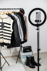 Empty workplace with smartphone and ring lamp, prepared for fashion blogger work, interior for fashion stylist, no people, freelance concept