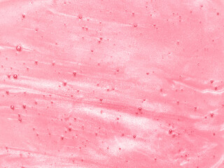 Pink lip gloss texture background. Smudged cosmetic product smear. Makup swatch product sample