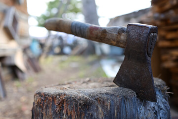 The wood chopper sticks out in wooden hemp. Ax and ax handle. Woodworking. 