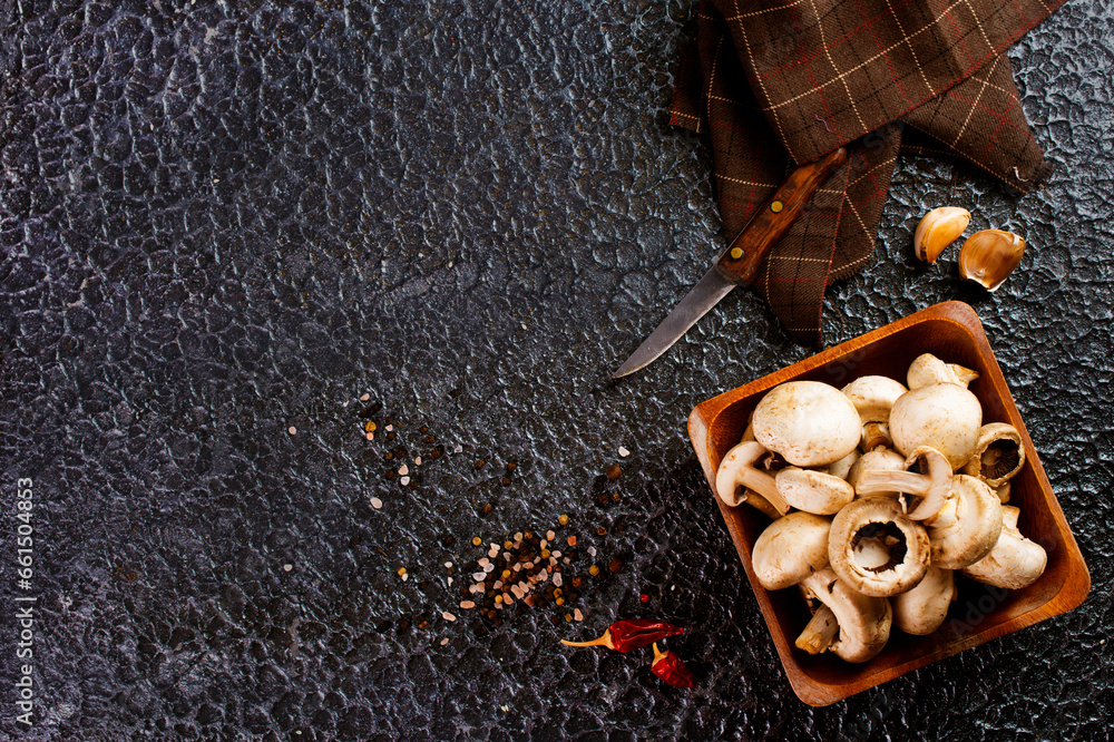 Sticker raw mushrooms champignons on black background, cooking fresh champignons