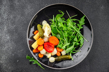 vegetable pickled salad cucumber, gherkin, carrot, onion, cauliflower, pepper appetizer meal food snack on the table copy space food background rustic top view