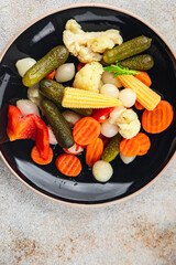 vegetable pickled salad cucumber, gherkin, carrot, onion, cauliflower, pepper appetizer meal food snack on the table copy space food background rustic top view