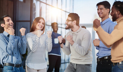 Business people celebrates and clench their fists in the air as a winning team