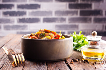 Fresh colorful spring vegetable salad with cherry tomatoes and sweet peppers in the bowl.