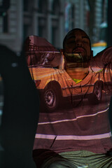 good looking man with beard and his arms crossed behind head in projector lights, fashion concept