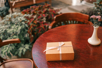 Gift box with bow in hands
