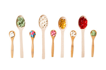 Top view Variety of vitamin and mineral pills in wooden spoon on Colored background. Top view of assorted pharmaceutical medicine pills. Dietary supplement healthcare product