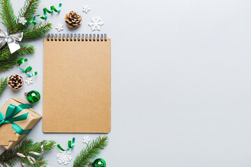 Christmas blank greeting card mock-up scene. Creative layout made of Christmas tree branches and paper card note. Flat lay. Nature New Year concept