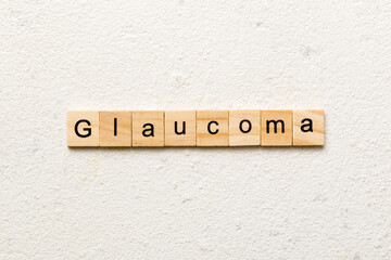 GLAUCOMA word written on wood block. GLAUCOMA text on cement table for your desing, concept